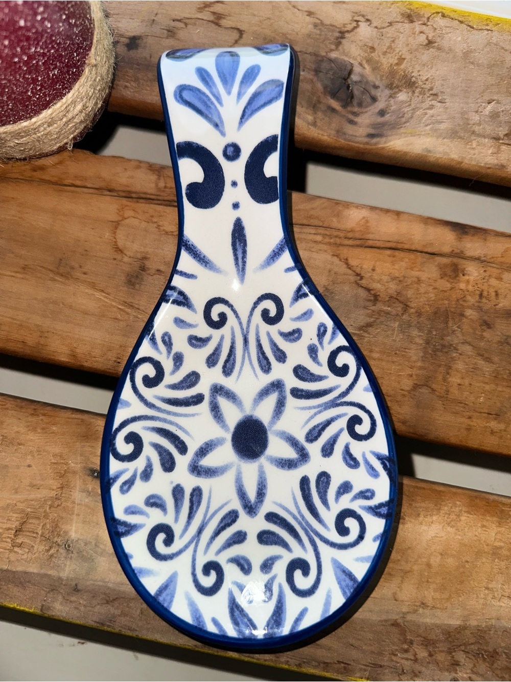 Ceramic spoon rest with a hand-painted blue and white floral pattern